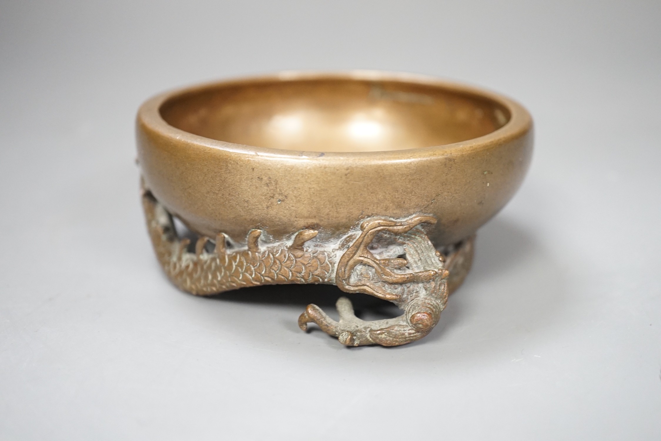 A Chinese or Japanese bronze ‘dragon’ dish, 13cm